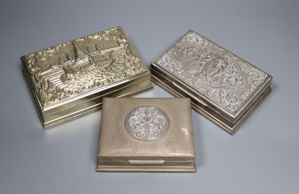 Three Thai white metal cigarette boxes, largest 16.1cm.